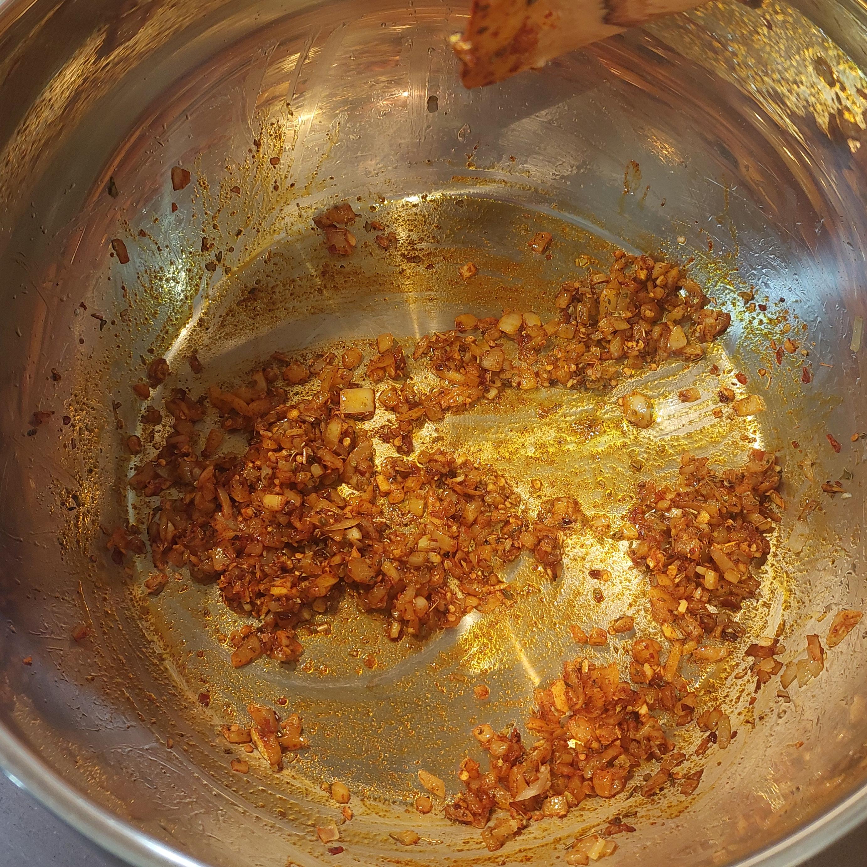 Heat oil and fry the onions until softened then add garlic. Stir in paprika, mixed herbs and chilli flakes.