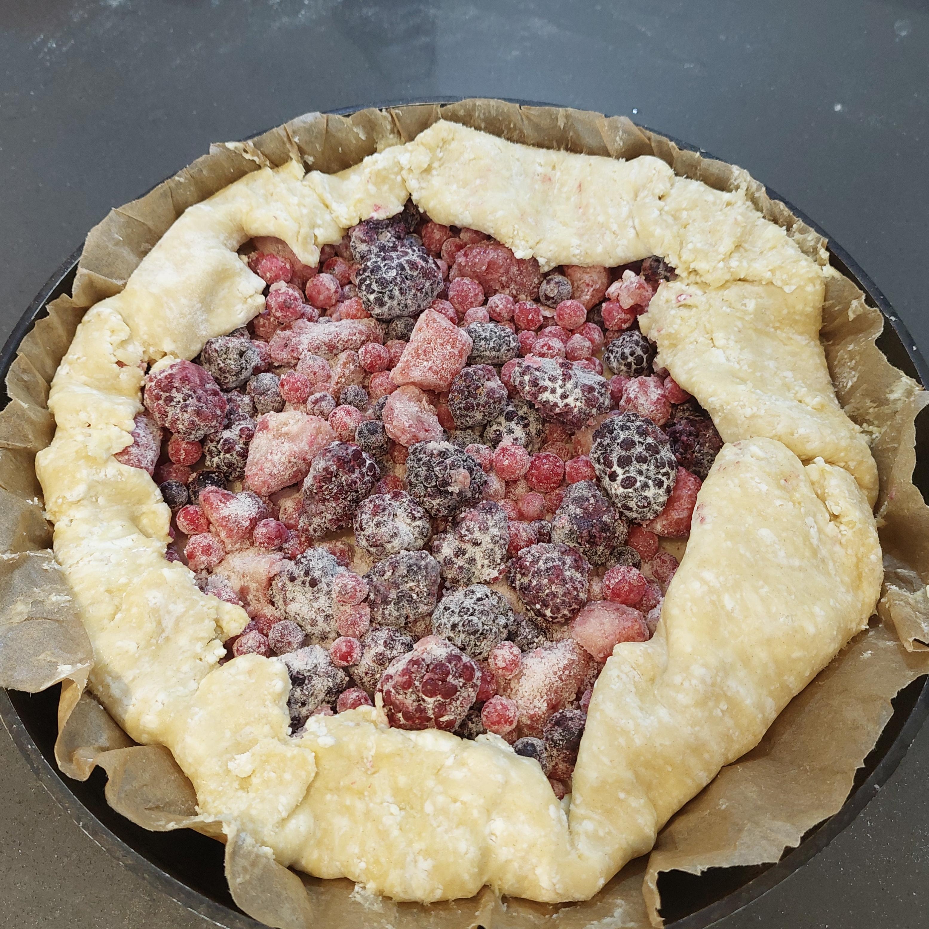 Fold dough edges inward covering some berries.