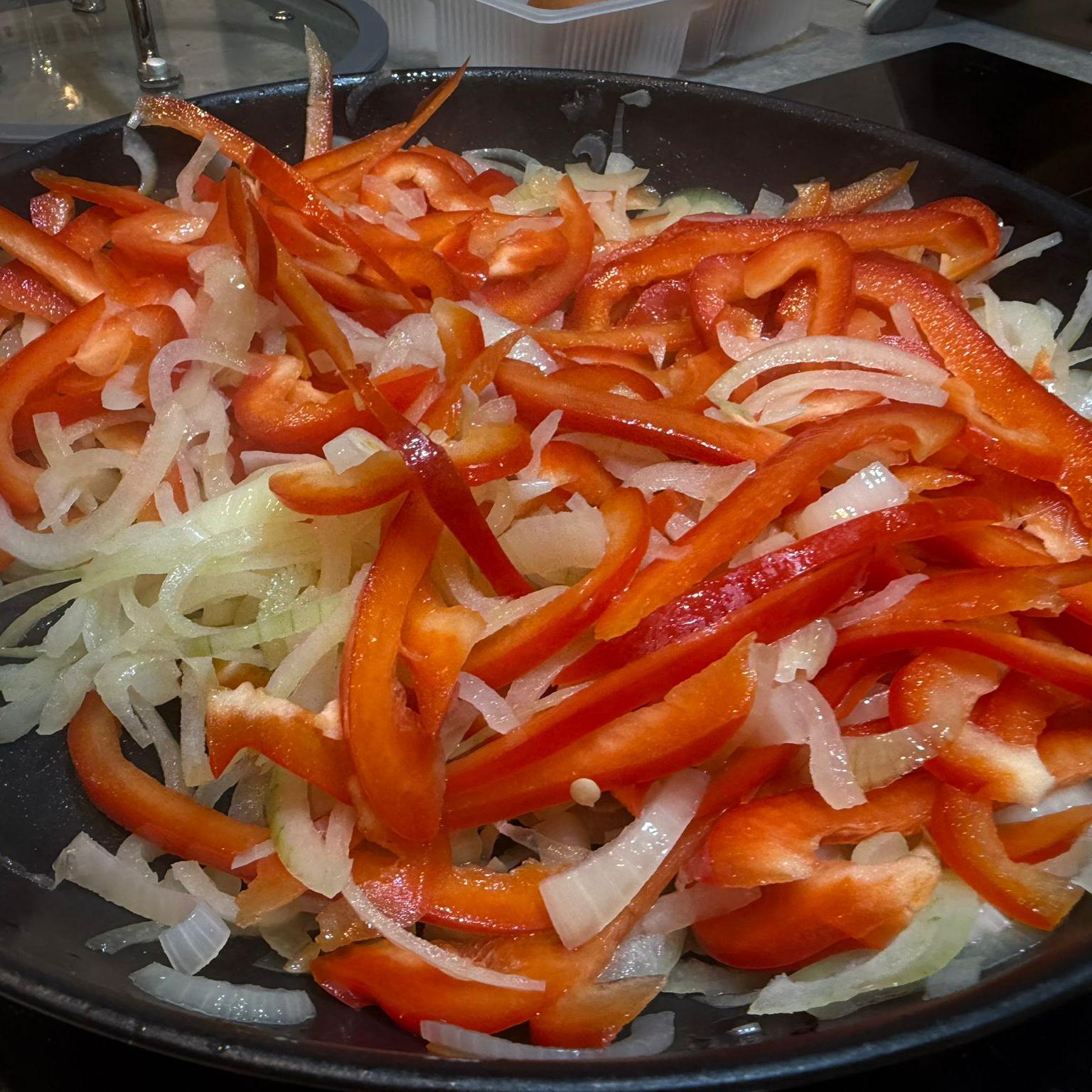 Stir fry onion and pepper until softened, 5-6 mins. Add salt and pepper. Add garlic and fry for one more minute.