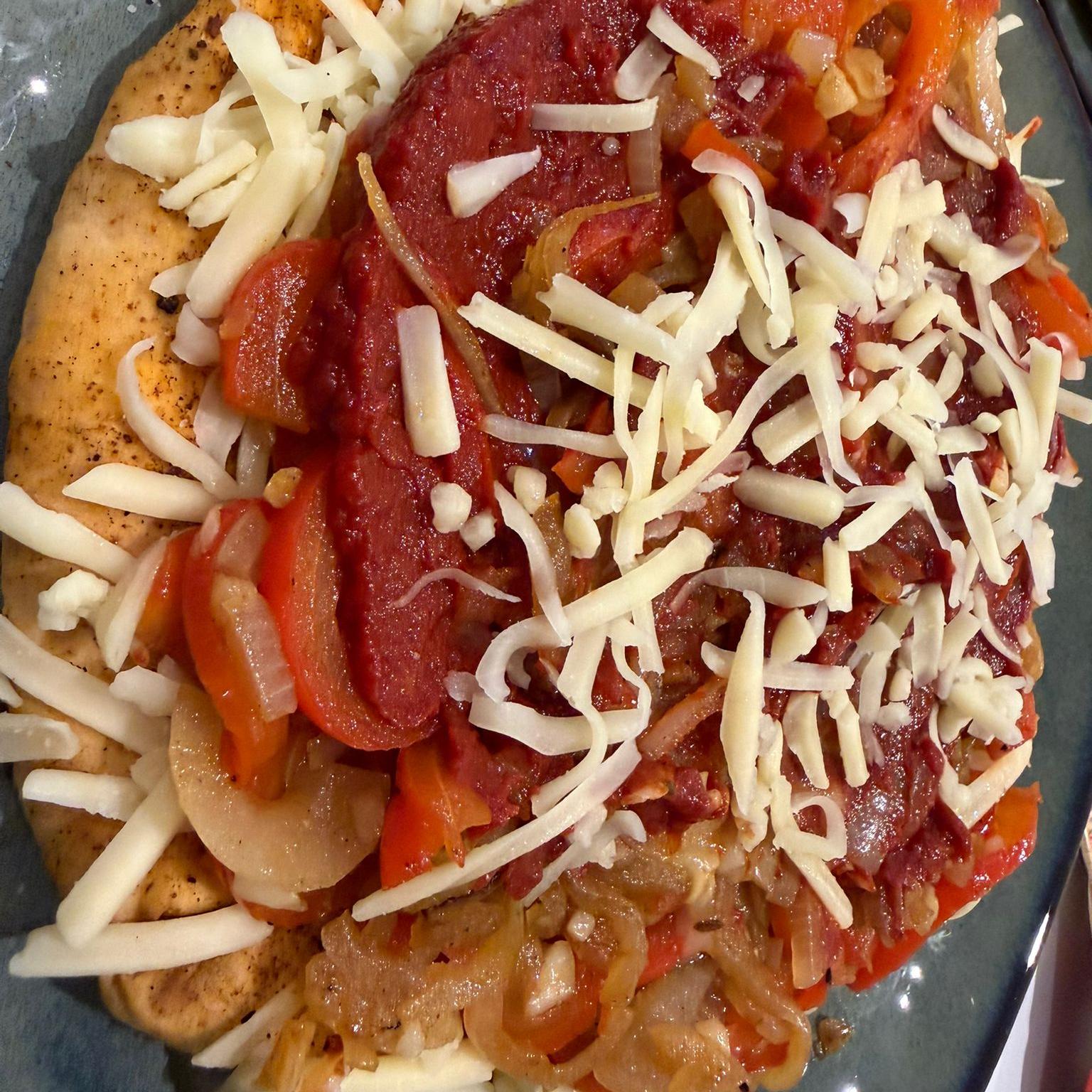 Top each naannizza with fried onions and peppers.