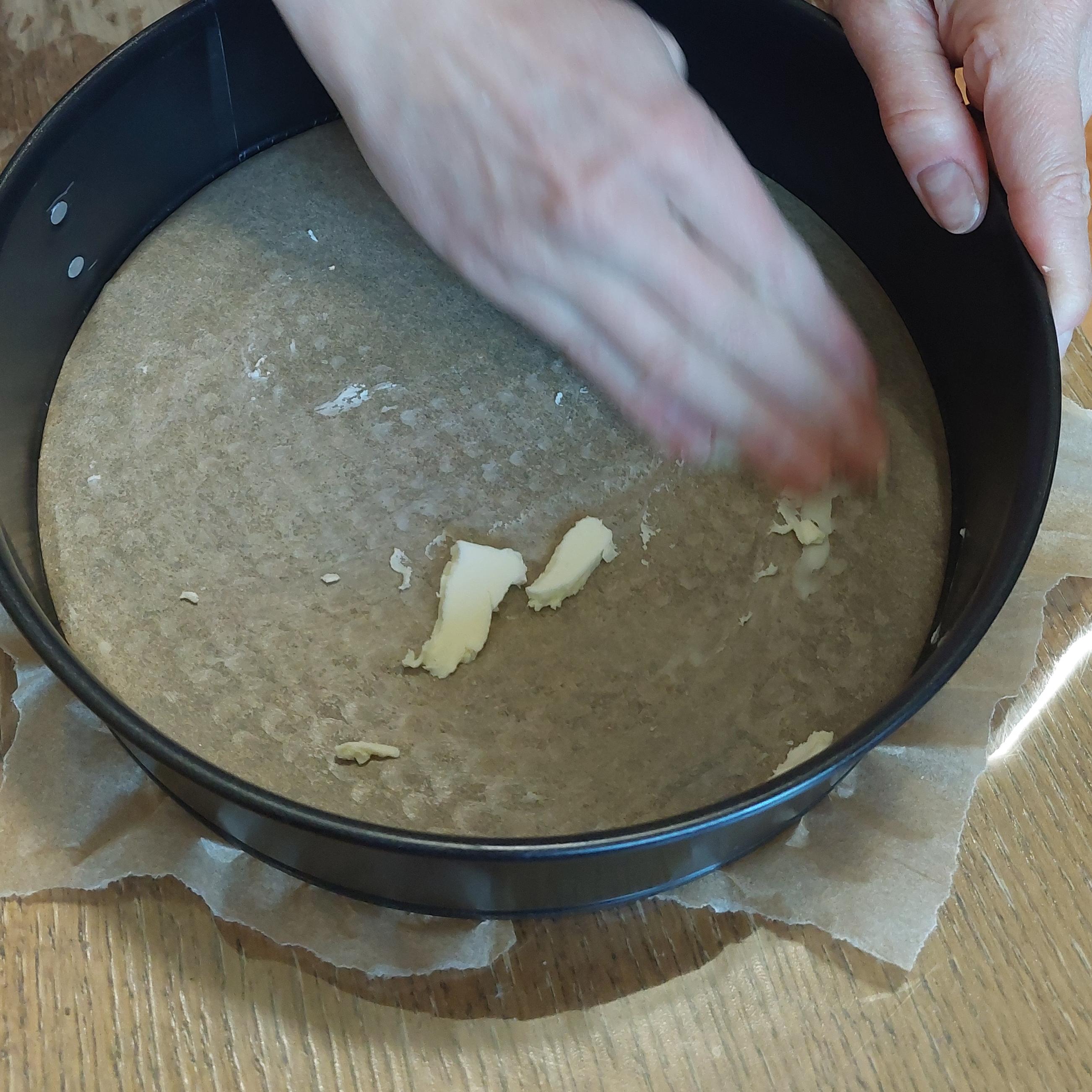 Line tray with baking paper and spread a thin layer of butter over it, including sides.