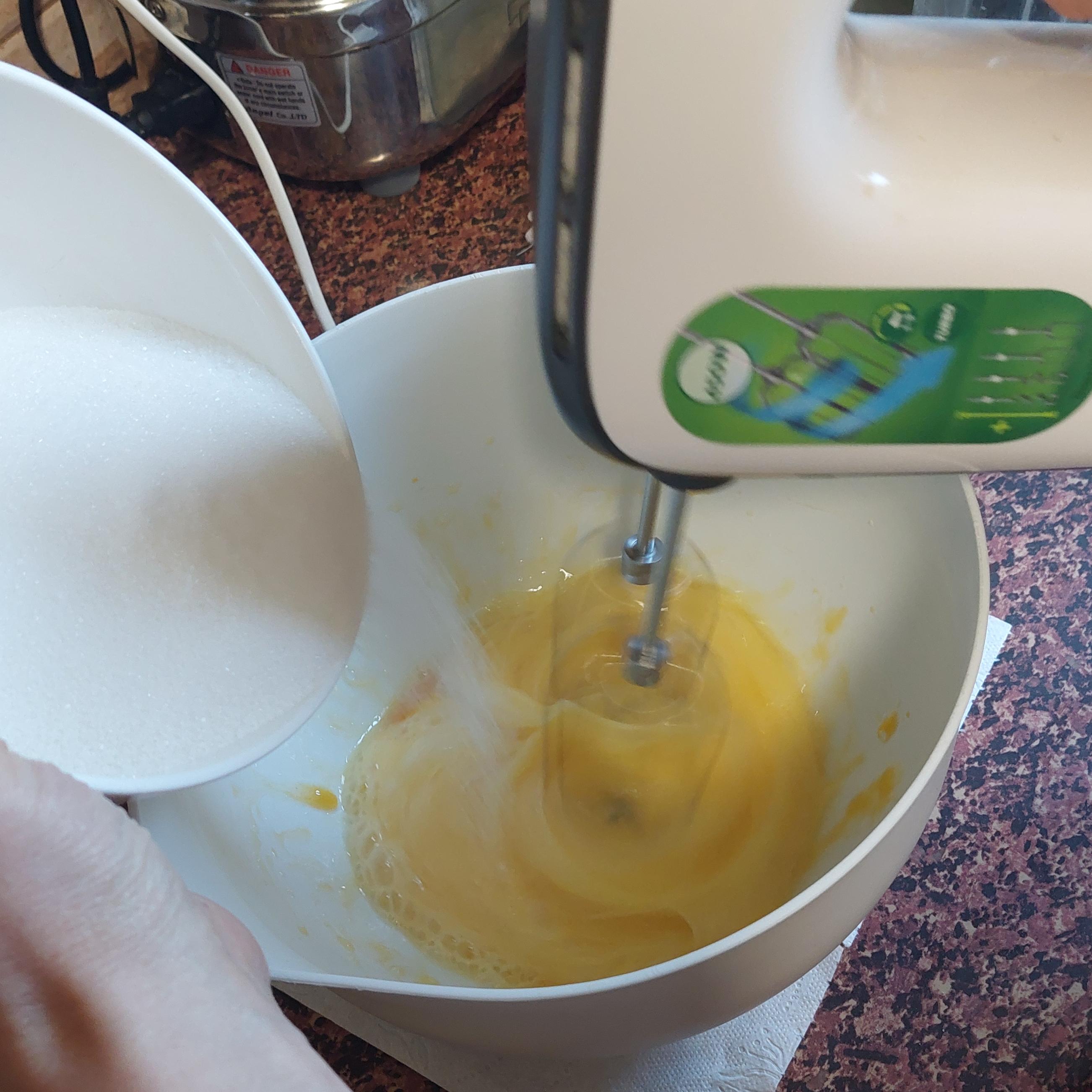 Start whipping eggs with a mixer, gradually adding sugar.