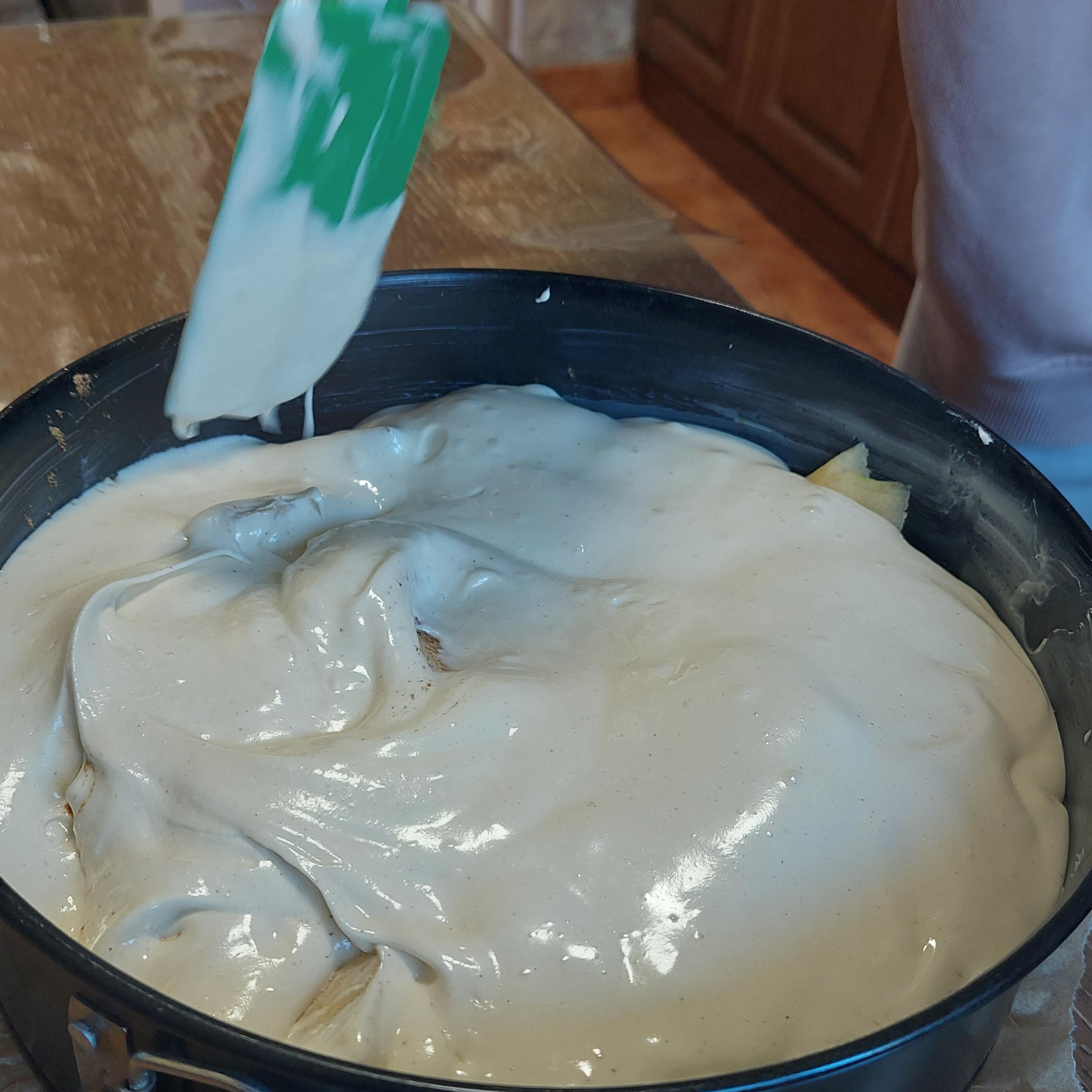 Gently stir and nudge the apple slices with a spatula so the thick mixture flows down, fills the gaps, and evenly coats everything.
